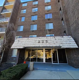 a view of a brick house with many windows