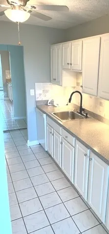 a kitchen with stainless steel appliances granite countertop a sink and cabinets