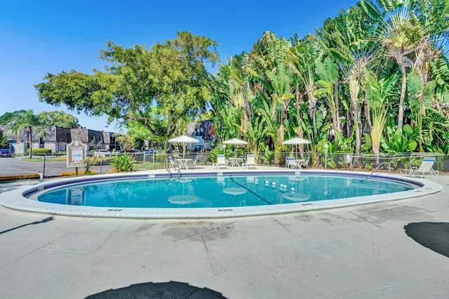 a view of a swimming pool with a yard