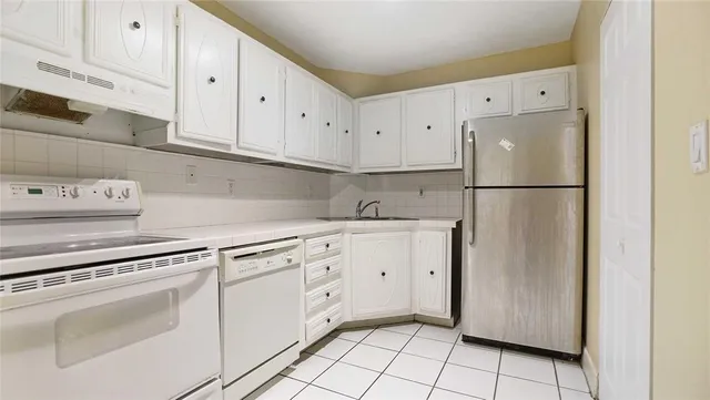 a white refrigerator freezer sitting in a kitchen