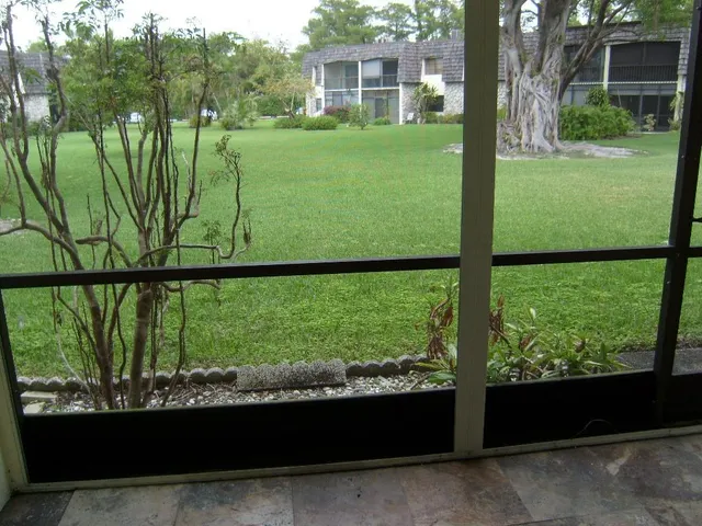 a front view of a building with a garden