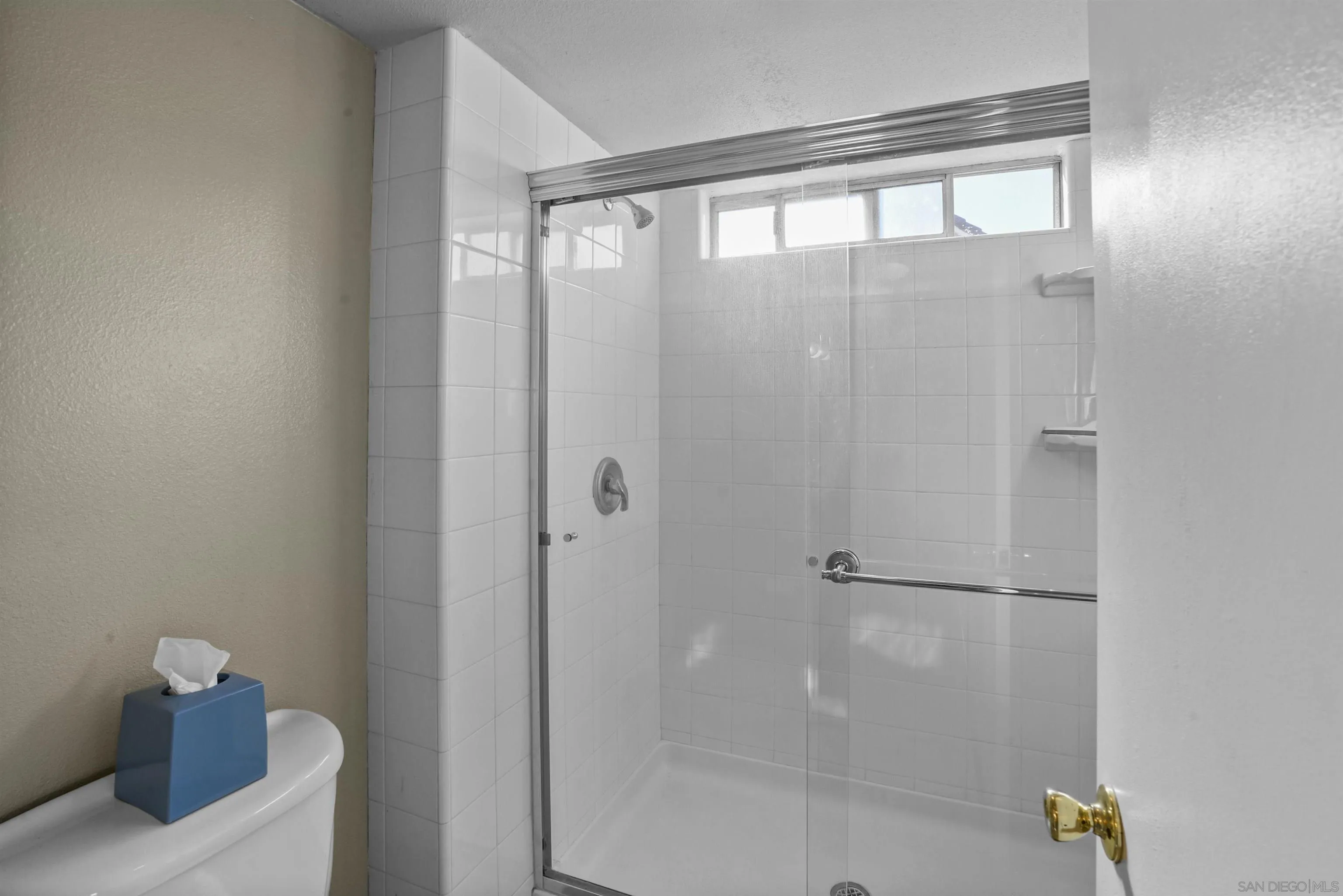 2119 Packard Place El Cajon, CA 92019 - Photo 18 of 29 a bathroom with a glass shower door