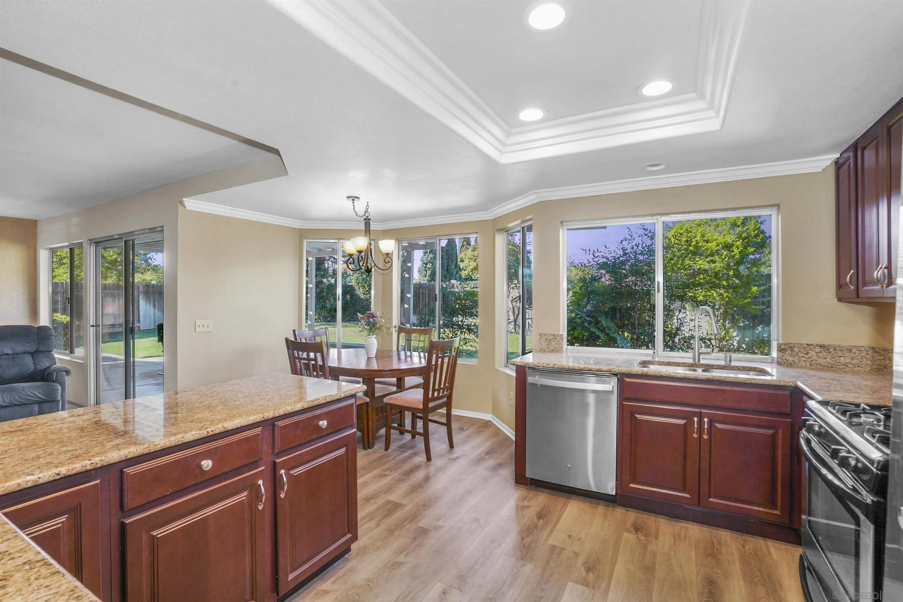 2119 Packard Place El Cajon, CA 92019 - Photo 2 of 29 a room with kitchen island granite countertop a large window a sink and counter space