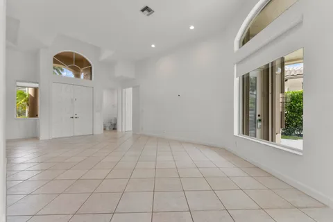 an empty room with windows and closet