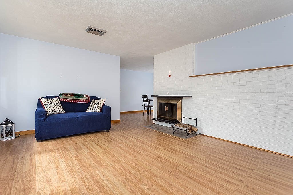 7 Nevada Road Chelmsford, MA 01824 - Photo 3 of 21 a living room with furniture and a fireplace