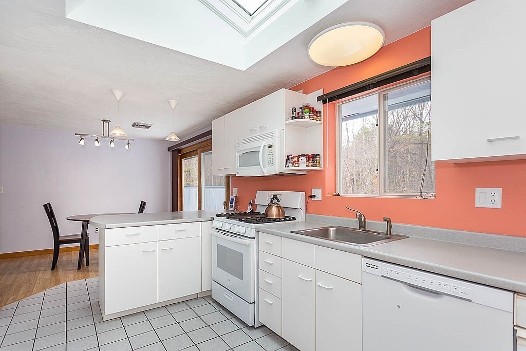 7 Nevada Road Chelmsford, MA 01824 - Photo 7 of 21 a kitchen that has a sink a stove and cabinets