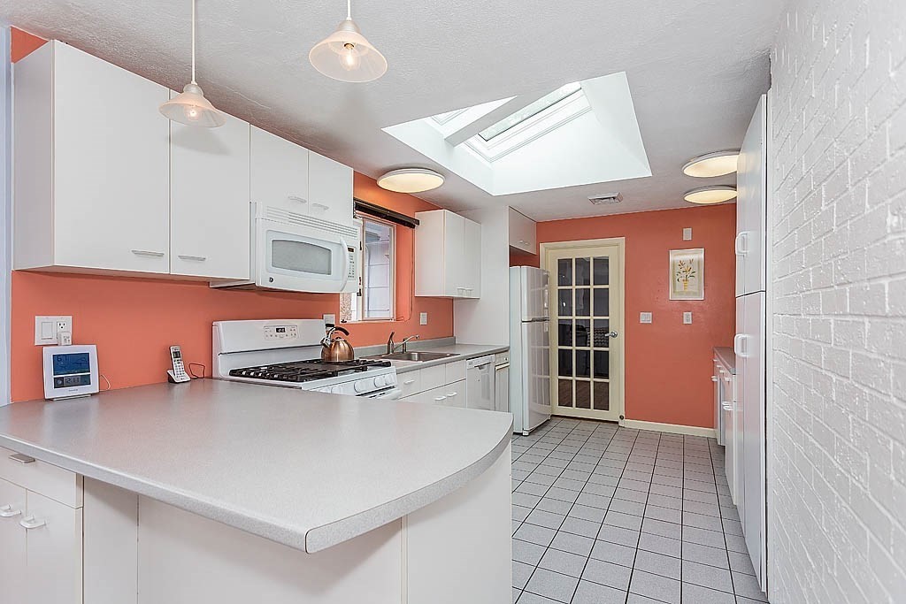 7 Nevada Road Chelmsford, MA 01824 - Photo 9 of 21 a kitchen with stainless steel appliances a stove a sink and cabinets