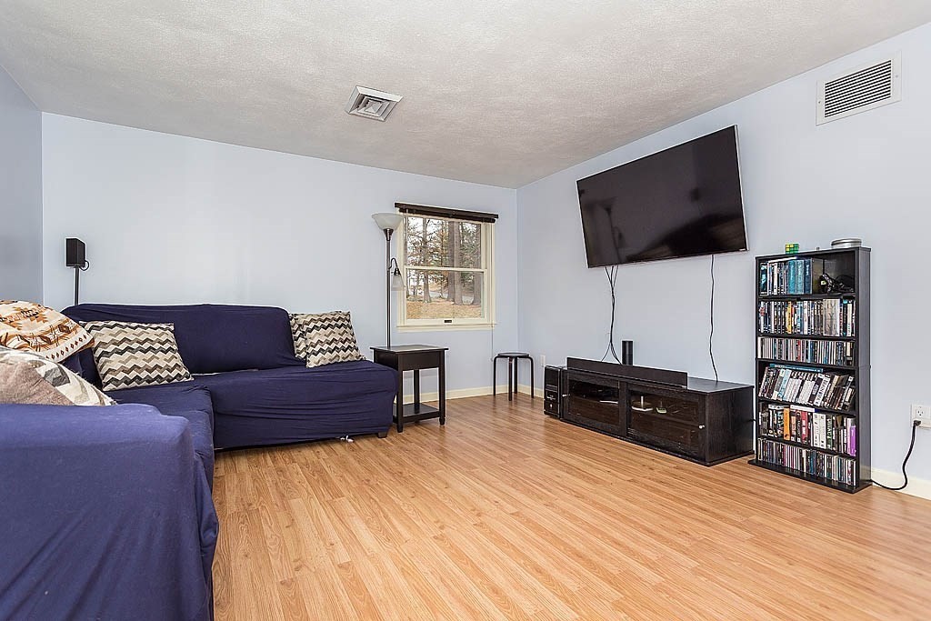 7 Nevada Road Chelmsford, MA 01824 - Photo 10 of 21 a living room with furniture and a flat screen tv