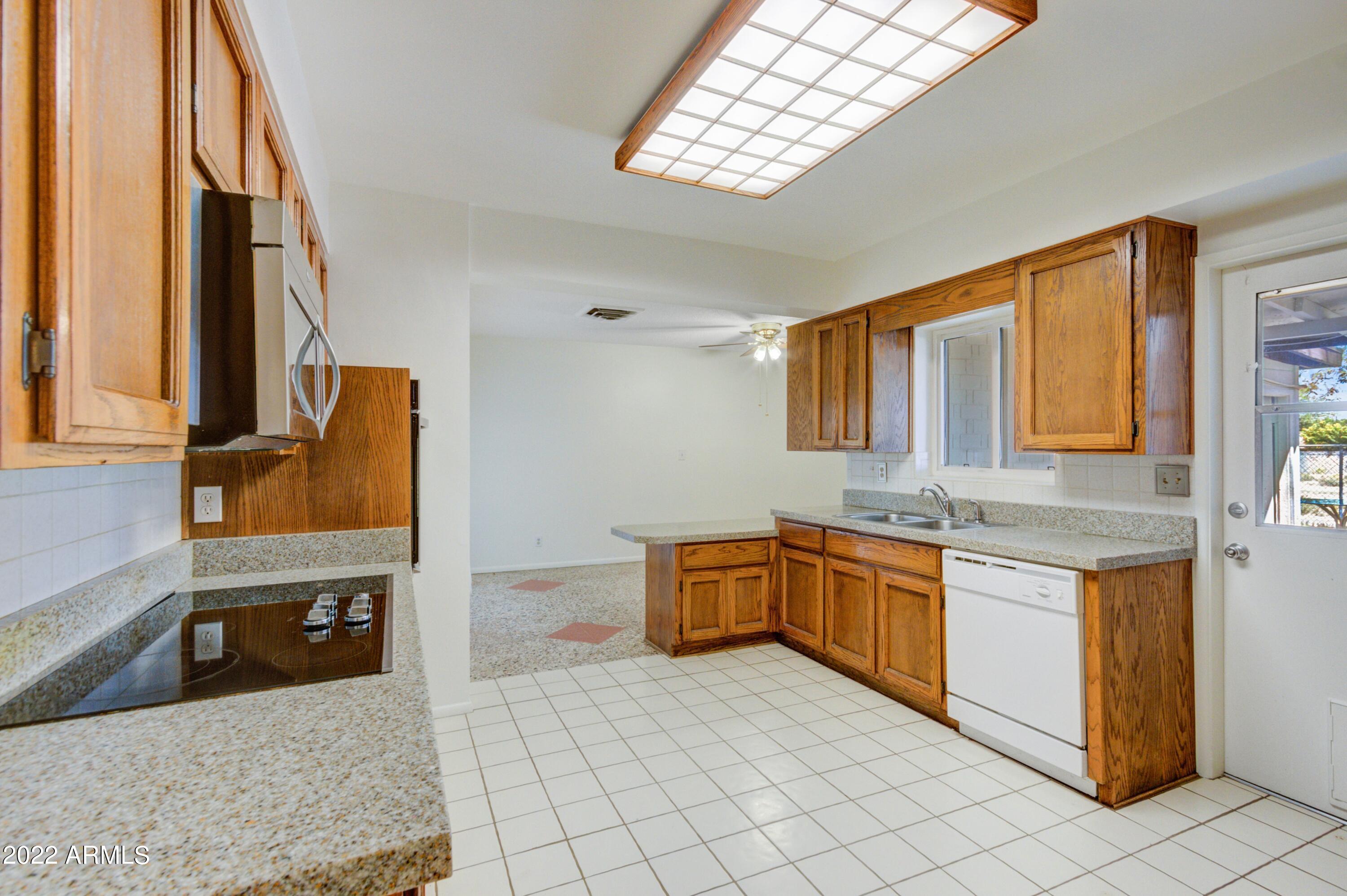 104 West Carson Road Phoenix, AZ 85041 - Photo 6 of 15 006_Kitchen To Dining Room