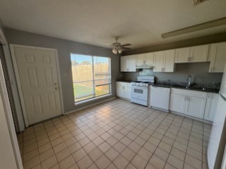 2319 Autumn Springs Lane Spring, TX 77373 - Photo 5 of 14 a kitchen with stainless steel appliances a sink stove and cabinets
