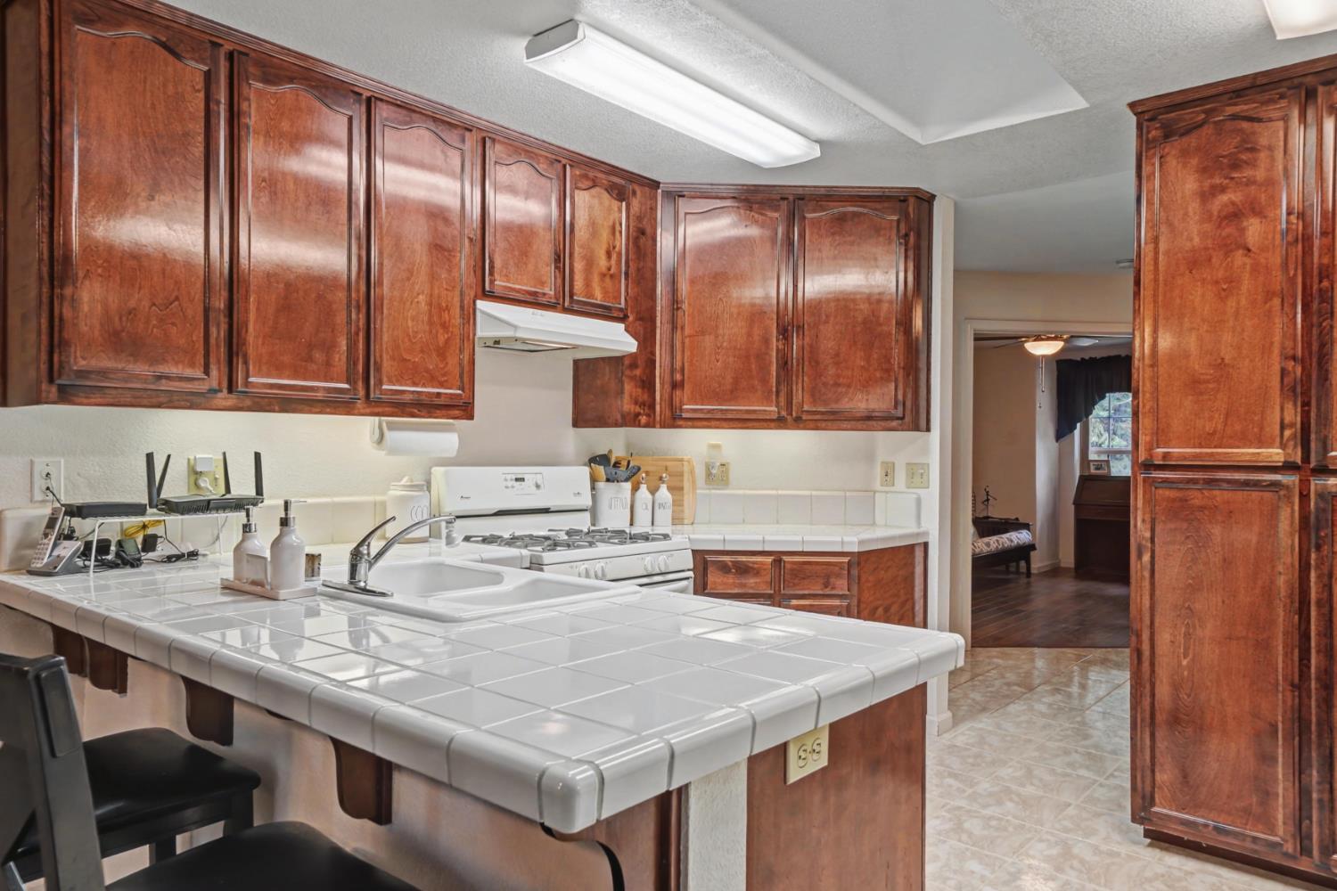 27390 Barton Road Pioneer, CA 95666 - Photo 17 of 52 a kitchen with granite countertop stainless steel appliances a sink and refrigerator