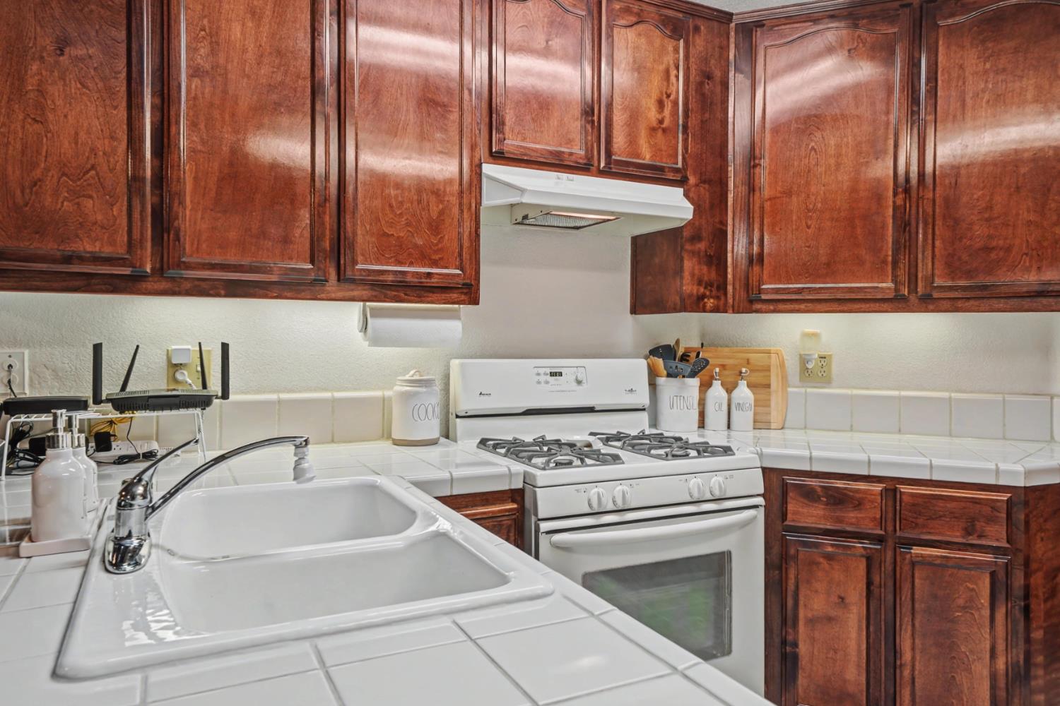 27390 Barton Road Pioneer, CA 95666 - Photo 18 of 52 a kitchen with granite countertop a sink a stove and cabinets