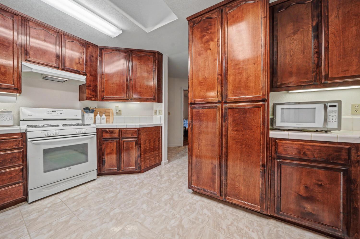 27390 Barton Road Pioneer, CA 95666 - Photo 19 of 52 a kitchen with granite countertop wooden cabinets and stainless steel appliances