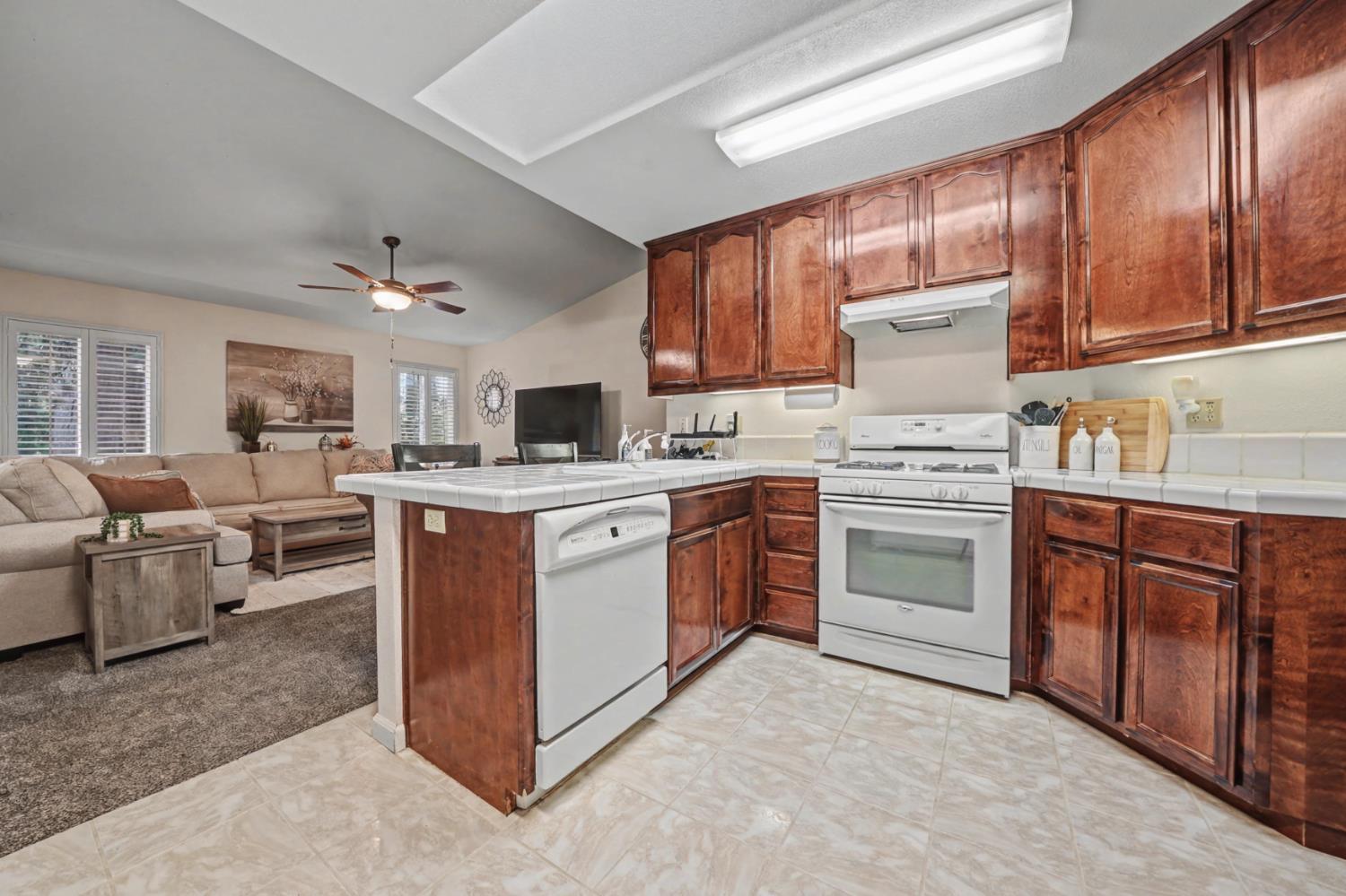 27390 Barton Road Pioneer, CA 95666 - Photo 20 of 52 a kitchen with kitchen island granite countertop a sink cabinets and stainless steel appliances