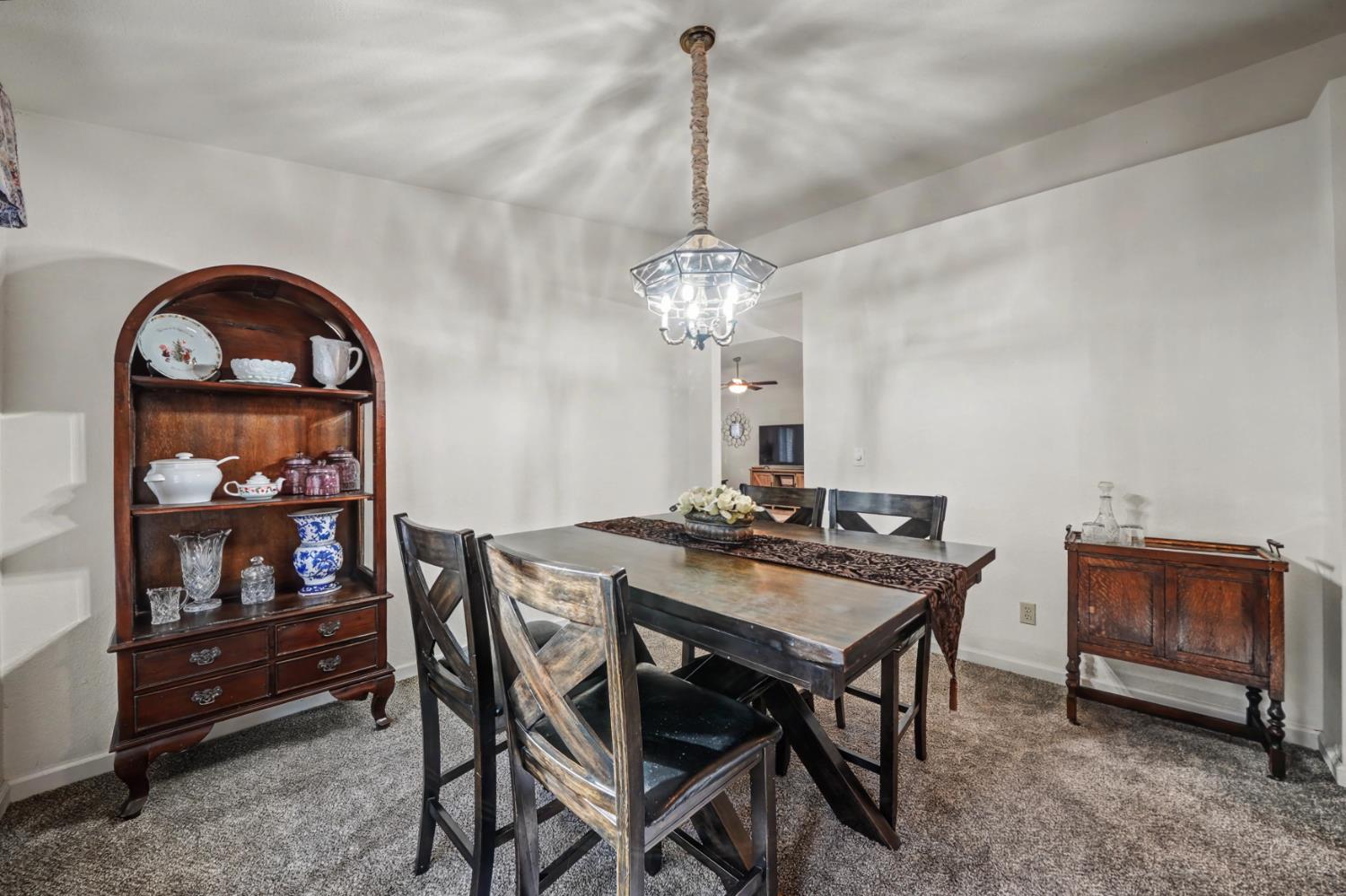 27390 Barton Road Pioneer, CA 95666 - Photo 25 of 52 a view of a dining room with furniture and chandelier