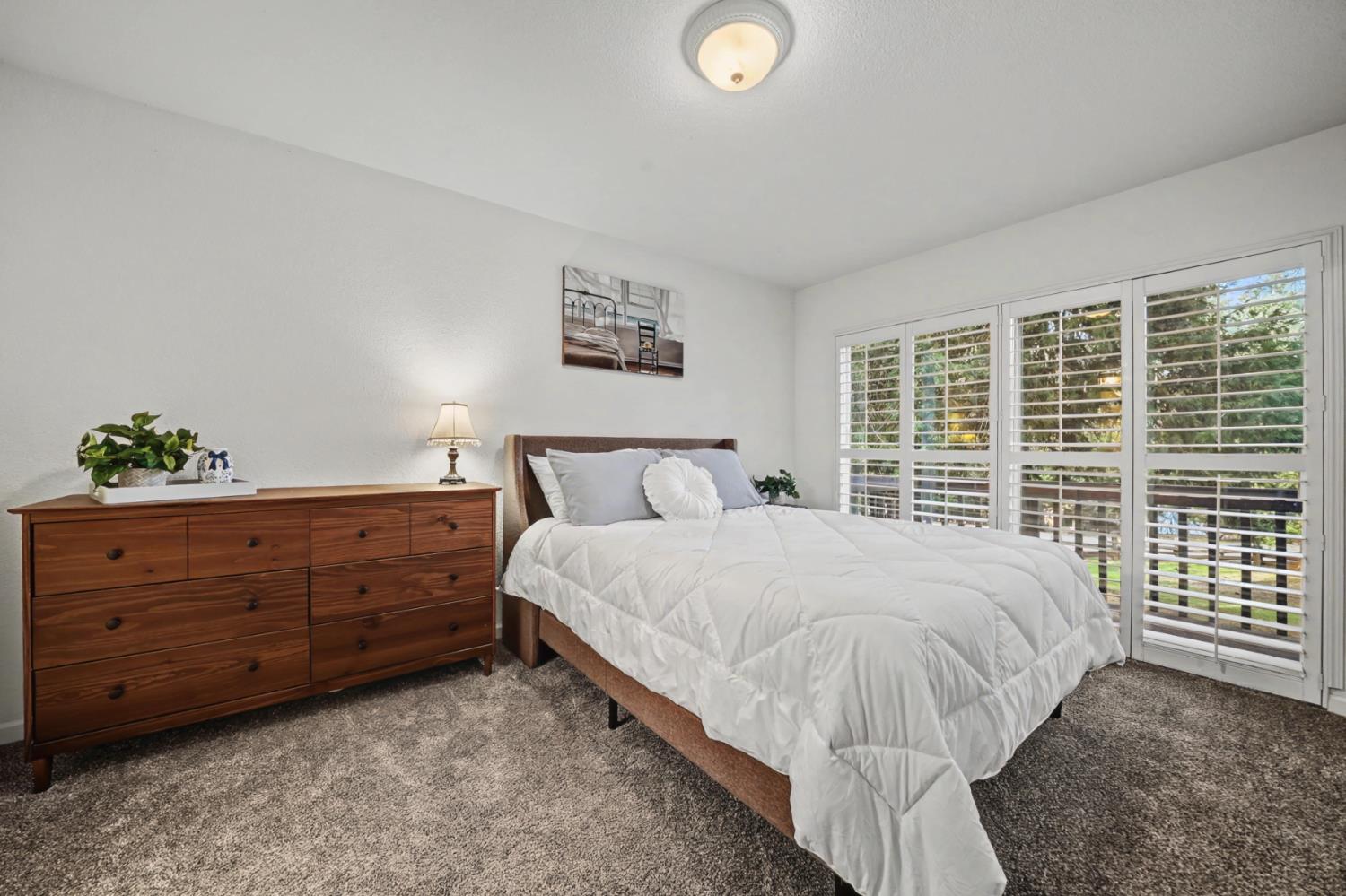 27390 Barton Road Pioneer, CA 95666 - Photo 32 of 52 a large bed sitting in a bedroom next to a window