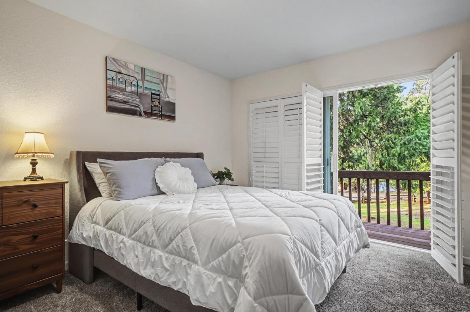 27390 Barton Road Pioneer, CA 95666 - Photo 34 of 52 a bedroom with a large bed and a window