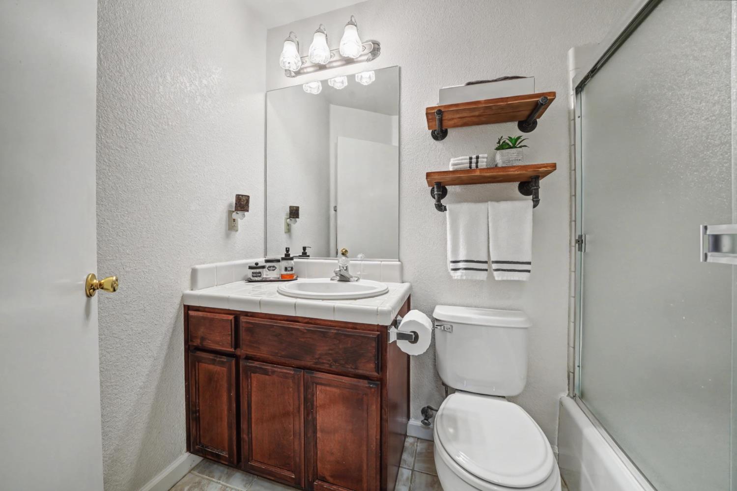 27390 Barton Road Pioneer, CA 95666 - Photo 36 of 52 a bathroom with a toilet a sink and mirror