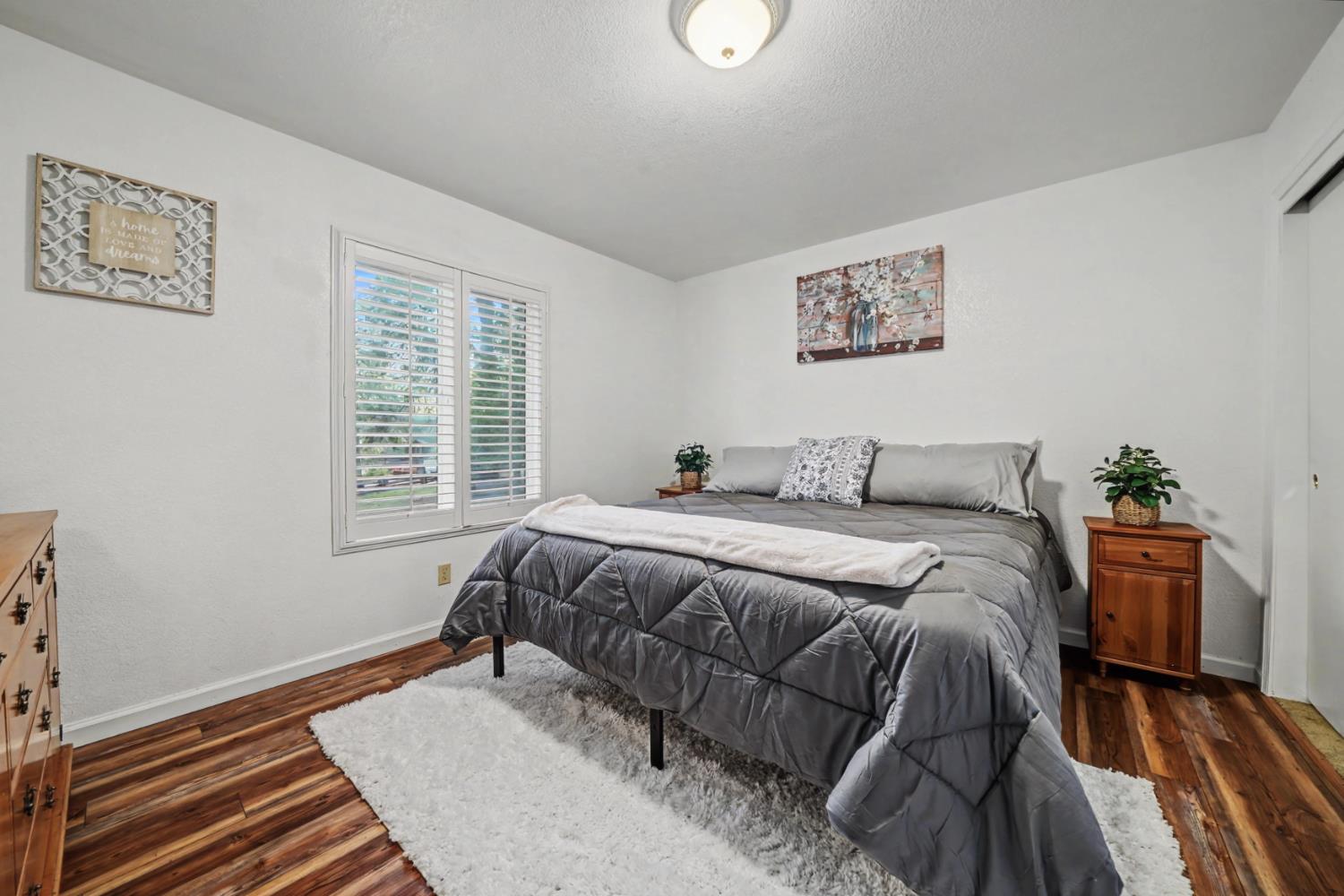 27390 Barton Road Pioneer, CA 95666 - Photo 38 of 52 a bed sitting in a bedroom next to a window