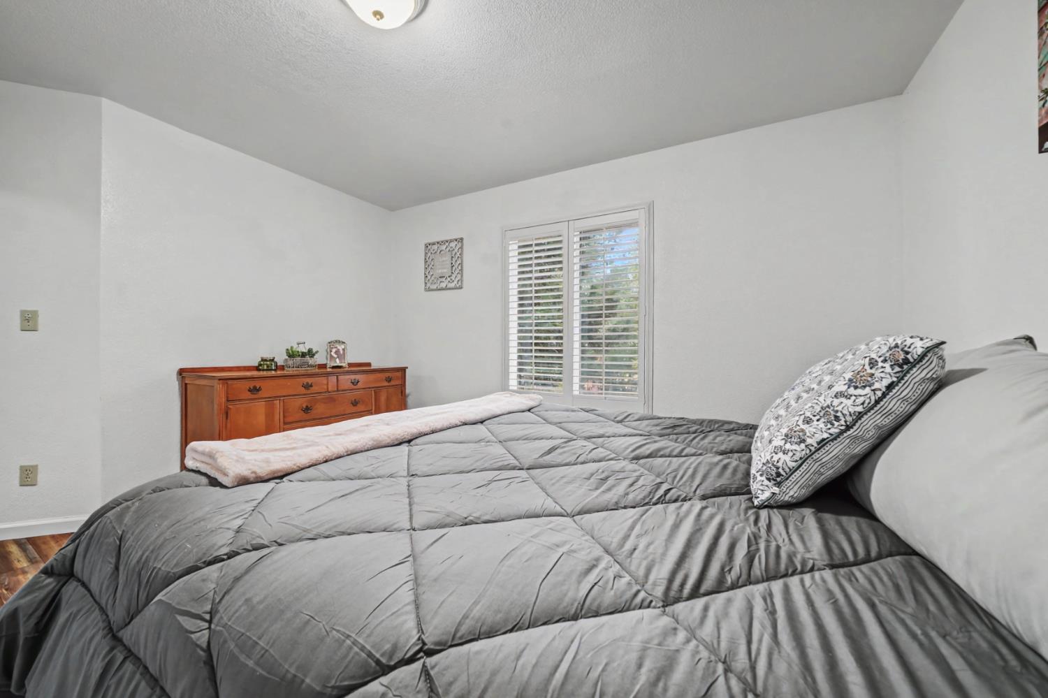 27390 Barton Road Pioneer, CA 95666 - Photo 39 of 52 a bedroom with a bed and wooden floor