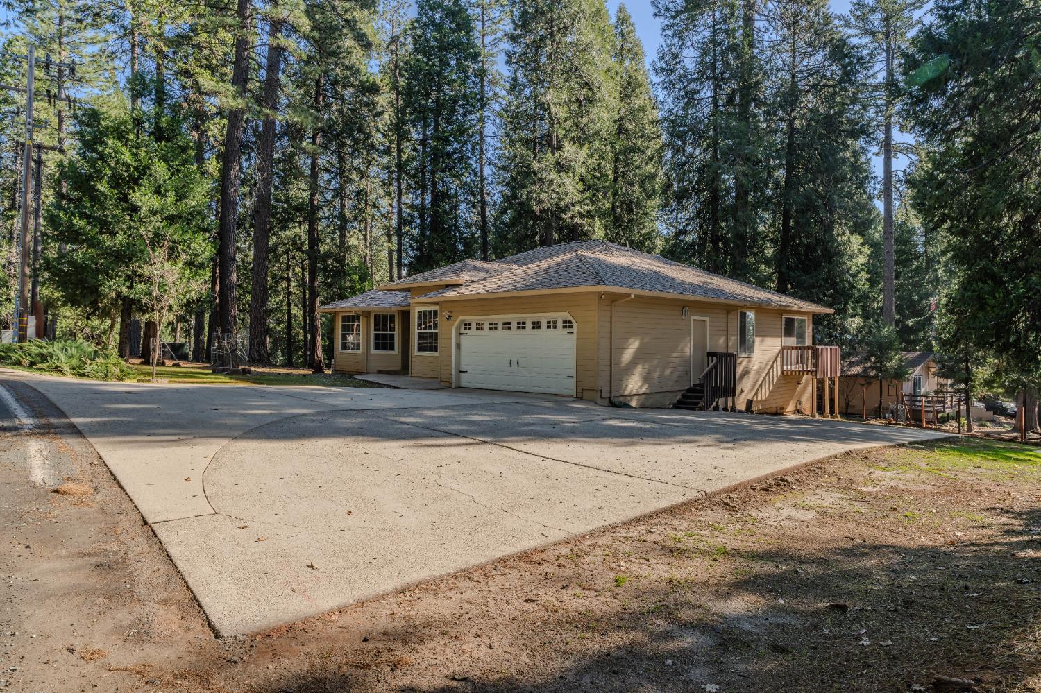 27390 Barton Road Pioneer, CA 95666 - Photo 50 of 52 a house with trees in front of it