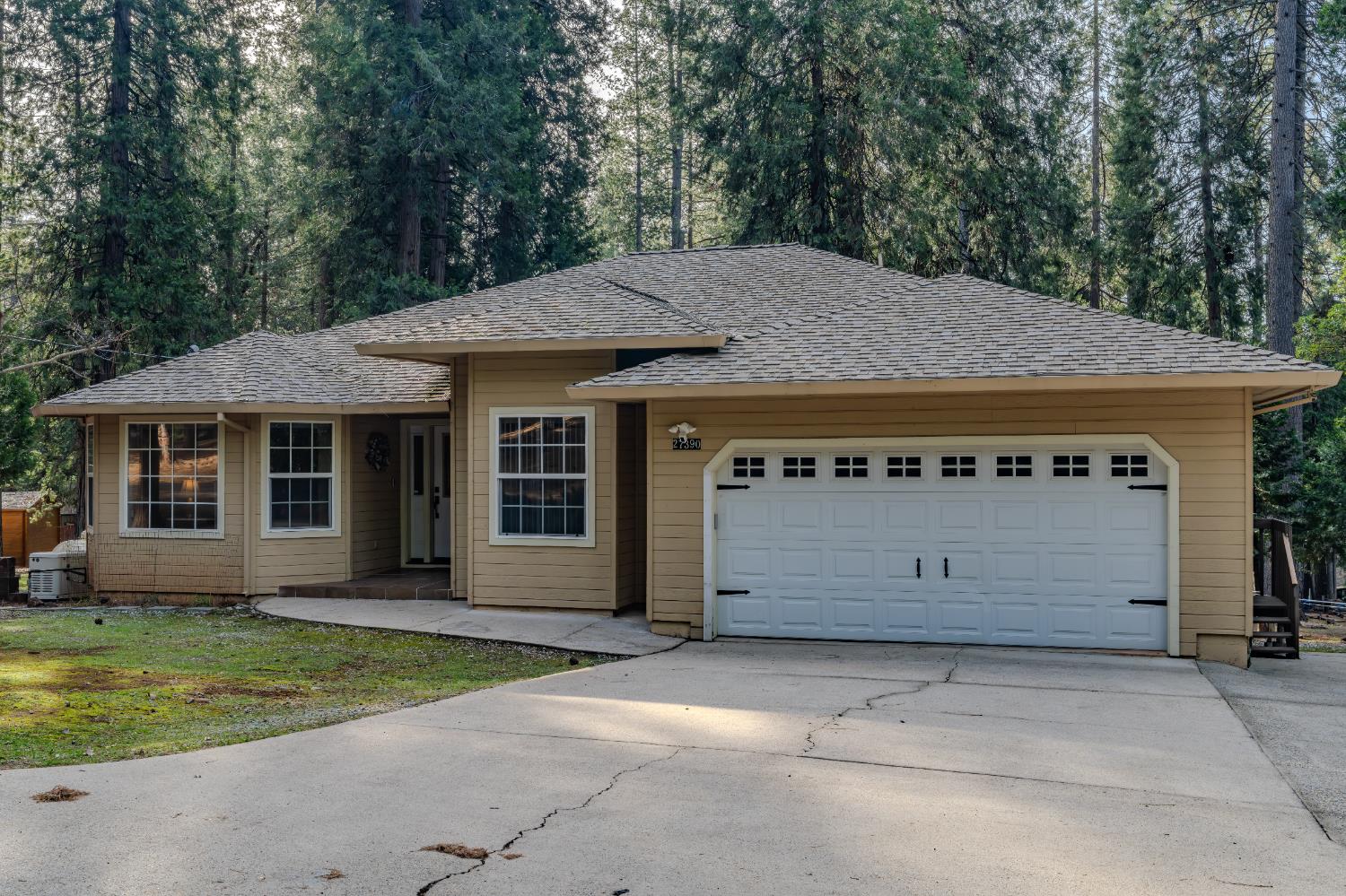 27390 Barton Road Pioneer, CA 95666 - Photo 52 of 52 a front view of a house with a garden and yard