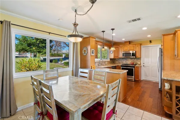 a kitchen with stainless steel appliances granite countertop a sink a stove and a refrigerator