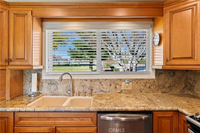 a view of a kitchen with a large window