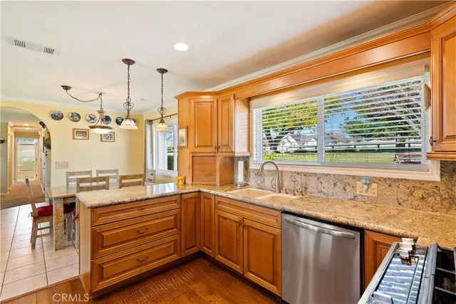 a kitchen with stainless steel appliances granite countertop a refrigerator stove and microwave