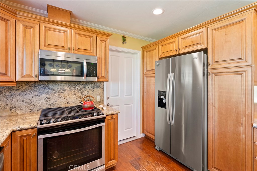 9220 Carmel Road Atascadero, CA 93422 - Photo 17 of 61 The kitchen boasts stainless steel appliances. Bonus, the refrigerator stays! The door leads to the attached 2-car garage.