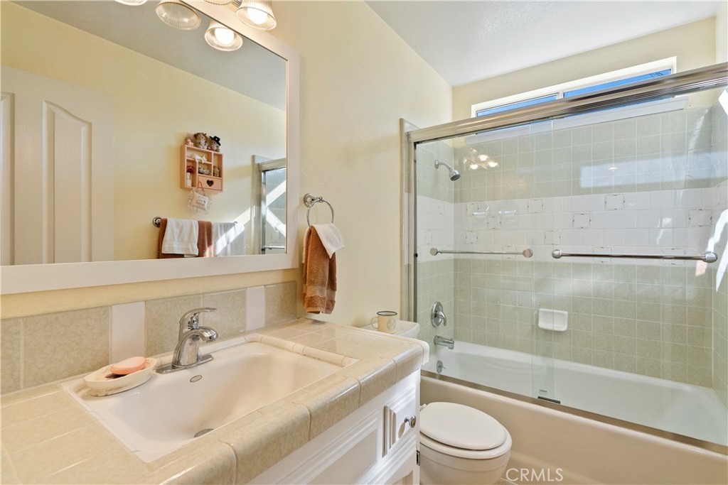 9220 Carmel Road Atascadero, CA 93422 - Photo 21 of 61 The main bathroom has a tiled tub/shower combination and a tile topped vanity.