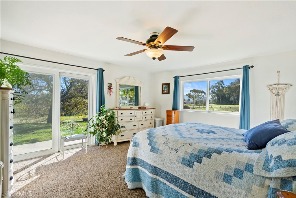 9220 Carmel Road Atascadero, CA 93422 - Photo 22 of 61 The primary bedroom is a lovely space with a sliding glass door that brings the outside in.