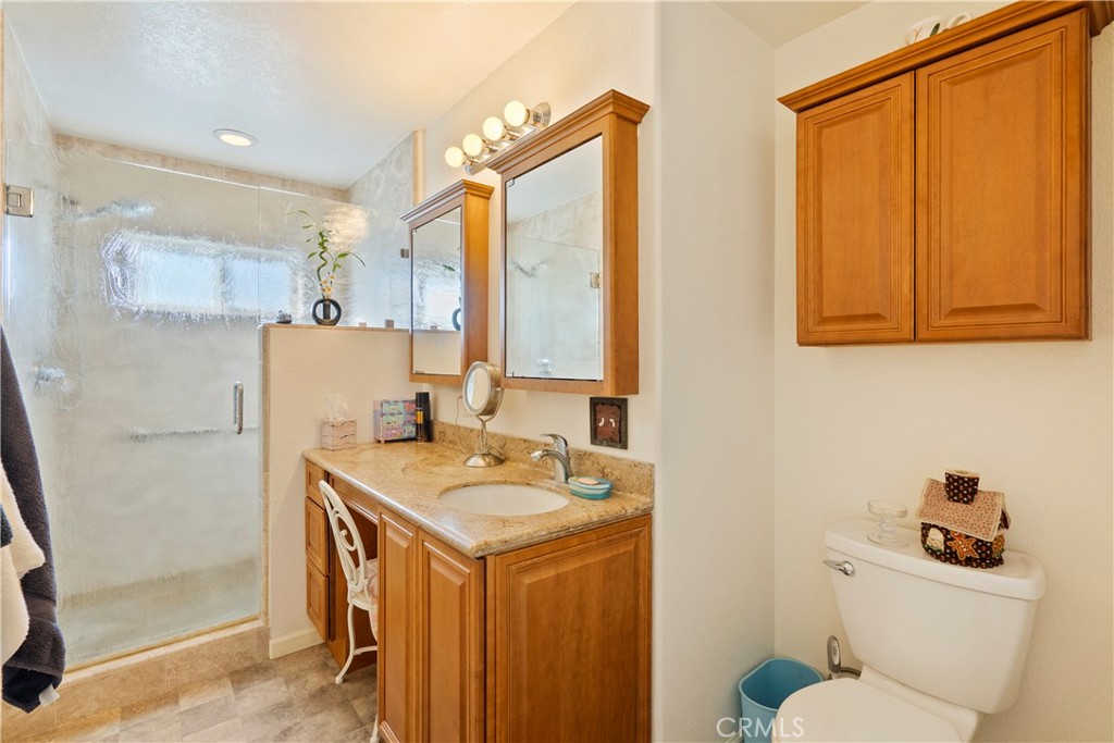9220 Carmel Road Atascadero, CA 93422 - Photo 25 of 61 The ensuite bathroom has a generous vanity with quartz countertop and large walk-in shower with decorative rain glass.