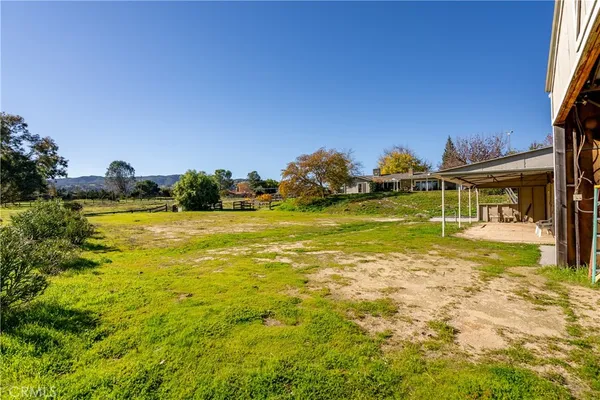 a view of a house with swimming pool and sitting area