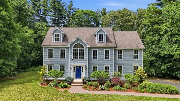 a aerial view of a house with yard and green space