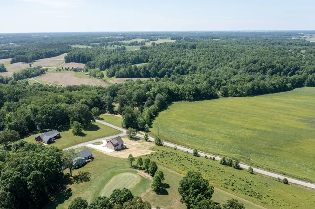 an aerial view of a houses with a yard