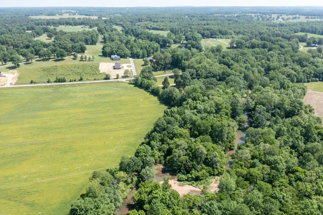 an aerial view of a house with a yard