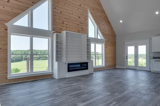 a kitchen with sink a microwave and cabinets