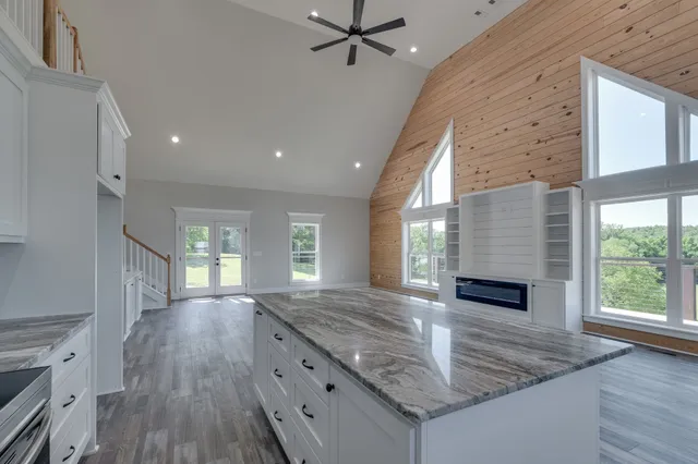 a view of a hallway with wooden floor and stairs