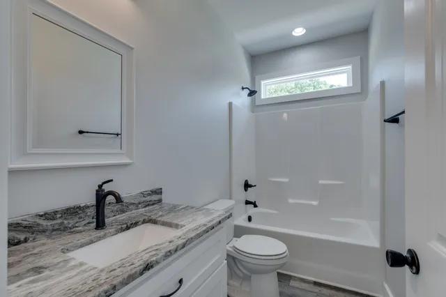 a bathroom with double sink and a mirror