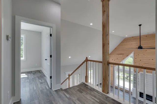 a bathroom with a granite countertop toilet sink and mirror