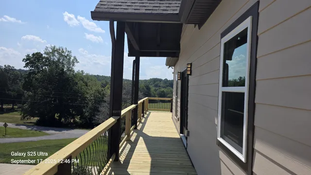 a view of balcony with wooden floor and lake view