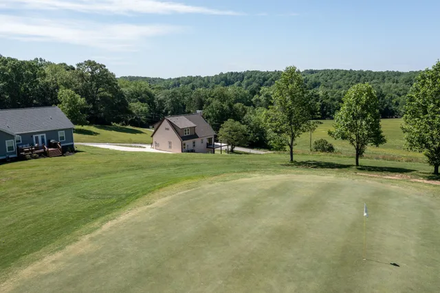 an aerial view of a house with a yard