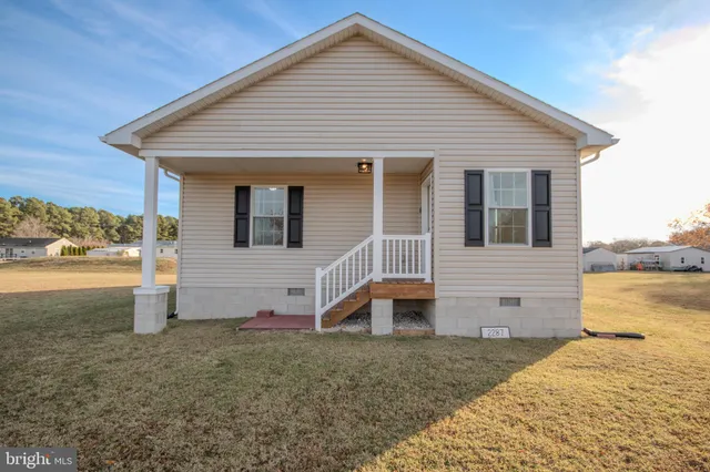 a view of a house with backyard and ocean