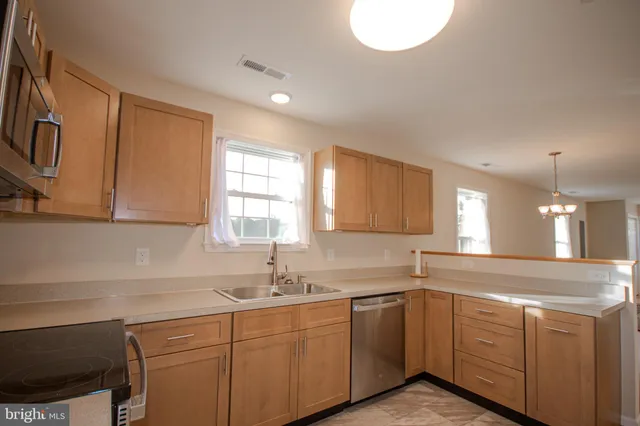 a kitchen with sink cabinets and window