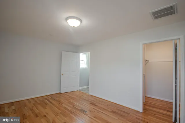 a view of an empty room and wooden floor