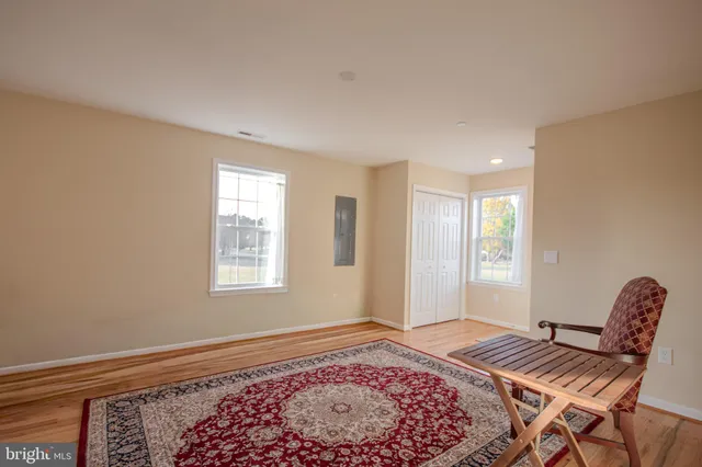 a view of a bedroom with bed and wooden floor