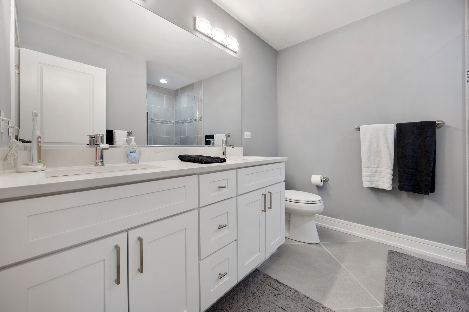 N112 Leonard Street Winfield, IL 60190 - Photo 14 of 26 a bathroom with a toilet a sink and mirror