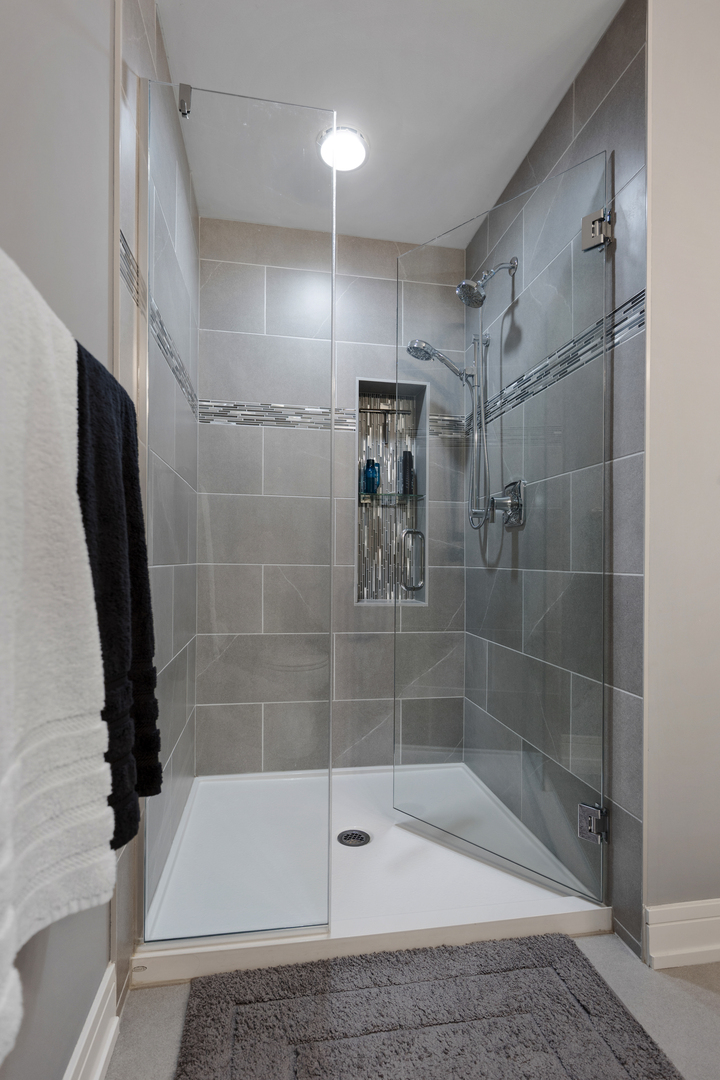 N112 Leonard Street Winfield, IL 60190 - Photo 15 of 26 a bathroom with a shower and a bathtub