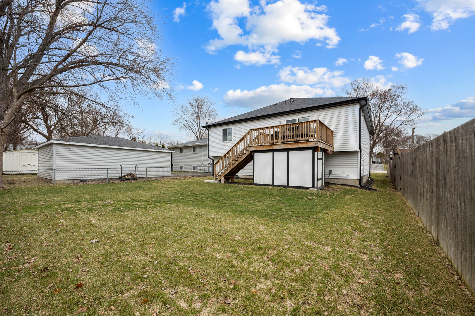 N112 Leonard Street Winfield, IL 60190 - Photo 24 of 26 a view of a big house with a big yard and large tree